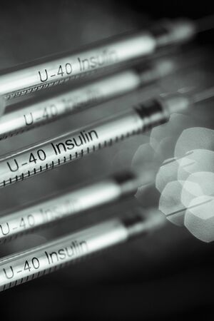 Insulin syringes on background out of focusの写真素材
