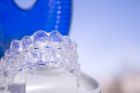 Invisible dental orthodontics in protective case on blue backgroundの写真素材