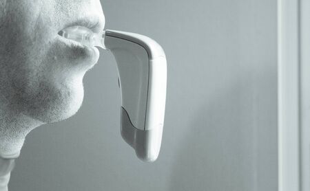 Vibrator for dental braces inside the mouth of a man