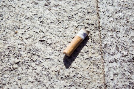 Cigarette butt off on isolated ground. No people.の写真素材