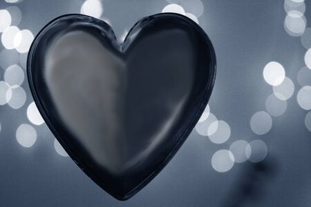 Red transparent heart on color backgroundの写真素材