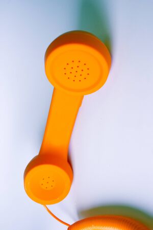 Orange analog phone. No people