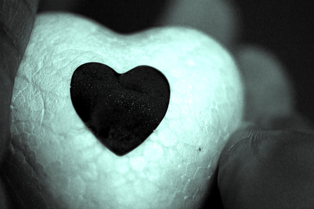 White heart made of polystyrene and bright black heartの写真素材
