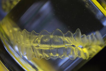 Invisible dental orthodontic submerged in water for cleaningの写真素材