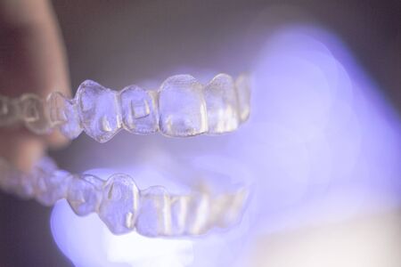 Invisible dental orthodontics on colored backgroundの写真素材