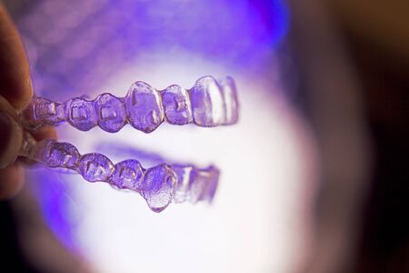 Invisible dental orthodontics on colored backgroundの写真素材