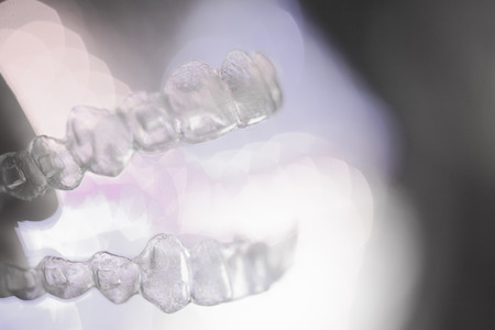 Invisible dental orthodontics on colored background