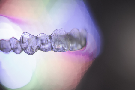 Invisible dental orthodontics on colored backgroundの写真素材