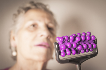 Elderly self massaging the body for painの写真素材