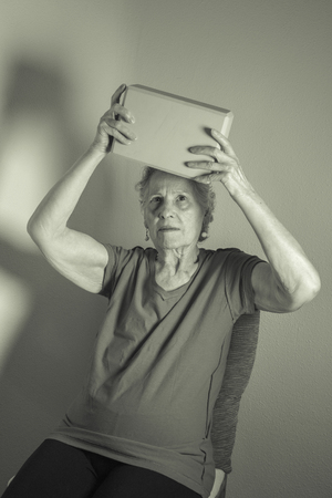 Rehabilitation for elderly woman with cerebral stroke with yoga exercisesの写真素材