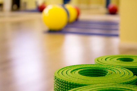 Yoga mat on wooden floor to perform meditation exercisesの写真素材