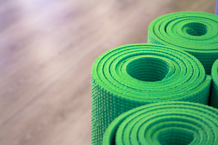 Yoga mat on wooden floor to perform meditation exercisesの写真素材
