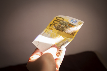 Intention to make a payment with a two hundred euro billの写真素材