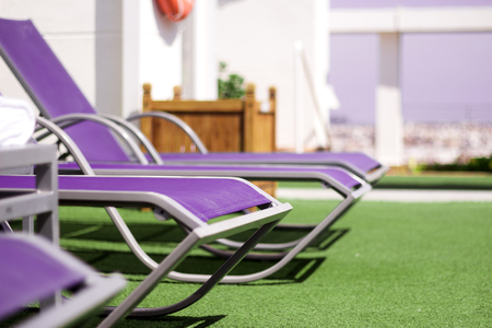 Part of pool in a hotel with sunbeds without peopleの写真素材