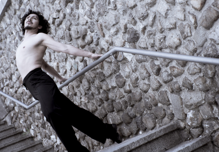 Male dancer doing a classic ballet pirouette. Urban backgroundの写真素材