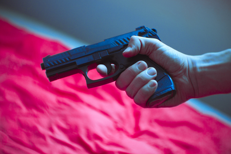 Gun held by a mans handの写真素材