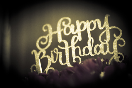 Flower arrangement with happy birthday signの写真素材