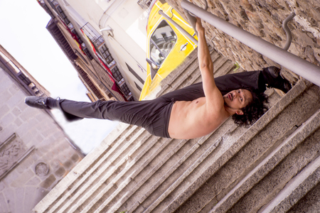 Male dancer doing a classic ballet pirouette. Urban backgroundの写真素材