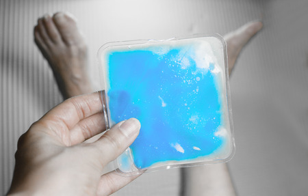 Old woman with ice pack for muscle achesの写真素材