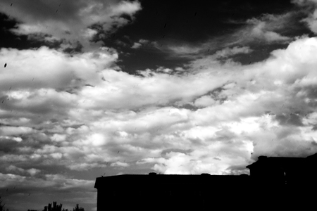 Sky in black and white with part of building. Dark scene and feeling sadの写真素材