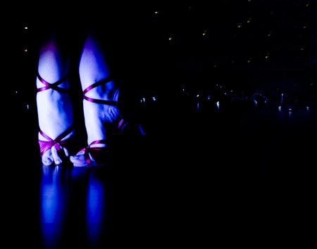 Woman with red dancing sandals in discoの写真素材