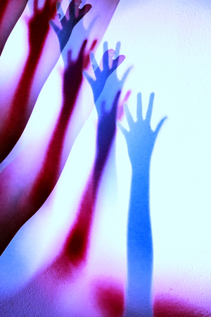 Extended arm with shadow in color, feeling of loneliness