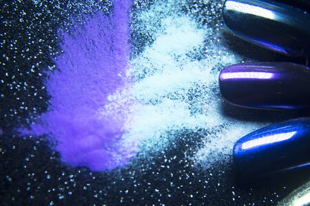 Gel nails next to acrylic powder to make them. Black backgroundの写真素材