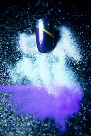 Gel nails next to acrylic powder to make them. Black backgroundの写真素材