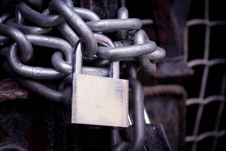 Closed door with chains and padlockの写真素材