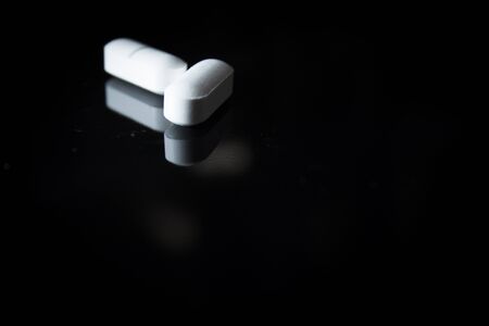 Woman holding generic white medicine pillsの写真素材