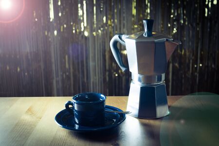 Cup of coffee next to classic Italian coffee makerの写真素材