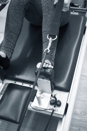 Woman doing pilates machine exercisesの写真素材