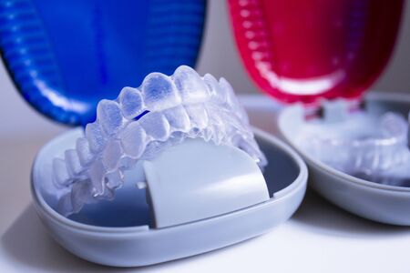 Blue and red boxes with invisible braces placed onlineの写真素材