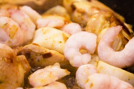 Vegetable stir fry with seafood and chicken to prepare paella. No peopleの写真素材