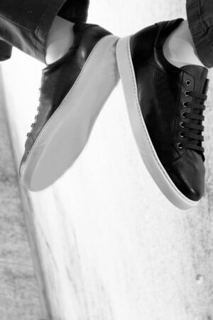 Mannequin foot of man in walking position reflected on the groundの写真素材