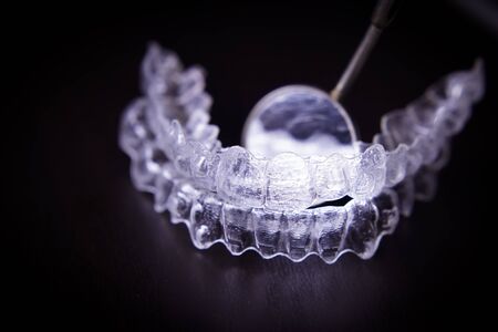 Transparent plastic dental retainer teeth alignment corrector with instruments for oral cleaningの写真素材