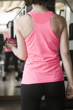 Girl doing exercise with 4 kg weights in the gymの写真素材