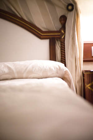 Antique bed with vintage bedspread. No people
