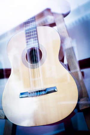 Spanish guitar musical instrument perched on a tripod. No peopleの写真素材
