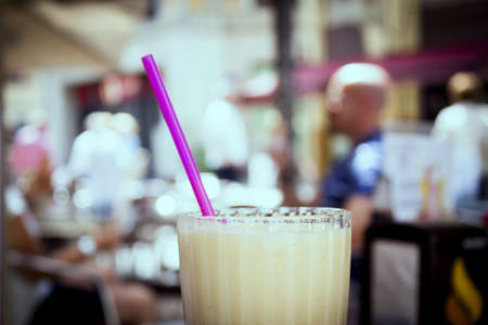 Glass bowl with fruit smoothie and drinking strawの写真素材