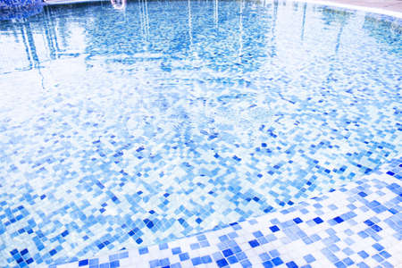 Circular pool with mosaic background in blue tones. No peopleの写真素材