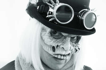 Woman with monster face and black hat wearing steampunk glasses. White hair.の写真素材