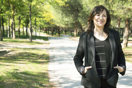 Mature woman in positive attitude sitting and standingの写真素材