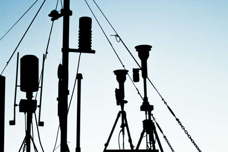 Weather station in silhouette over the sky at sunset. No peopleの写真素材