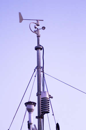 Weather station in silhouette over the sky at sunset. No peopleの写真素材