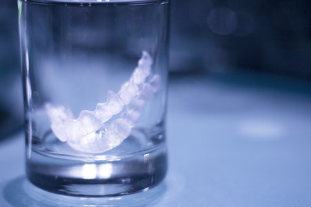 Transparent tooth aligner inside a crystal glass. No people