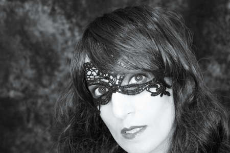 Woman disguised in gothic style for halloween party with maskの写真素材