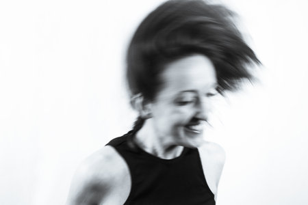 Motion blur portrait of woman over 40. Black tshirtの写真素材