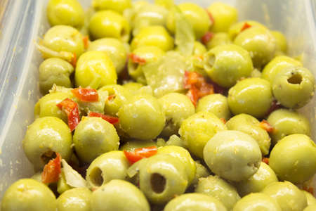 Pitted and pitted green olives with pepper and carrot. No copy spaceの写真素材