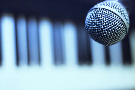 Microphone over piano keys in dim light. No peopleの写真素材